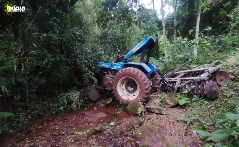Mulher fica ferida após trator cair em ribanceira